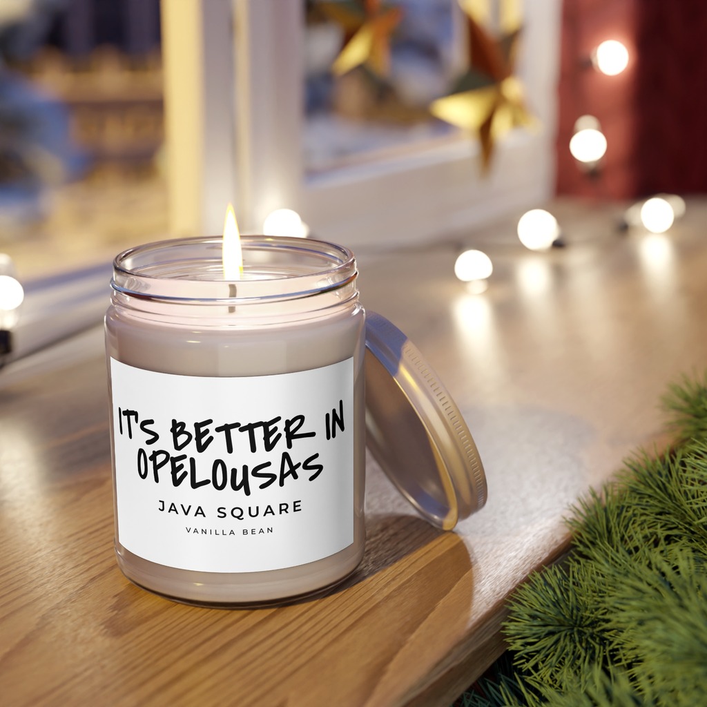 Java Square Soy Candle in Vanilla Bean, lit on a windowsill
